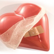 Ett plasthjärta med plåster och bandage