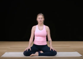 Kvinna på yogamatta gör andningsövning mot stress