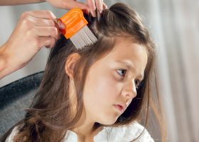 mother-using-a-comb-to-look-for-head-lice-picture-id497631674 (1)