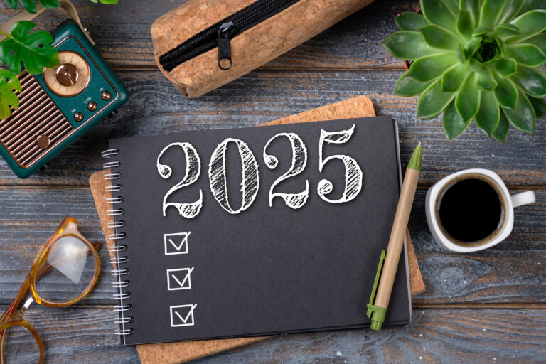 New year resolutions 2025 on desk. 2025 goals list with notebook, coffee cup, plant on wooden table. Resolutions, plan, goals, action, checklist, idea concept. New Year 2025 resolutions, copy space