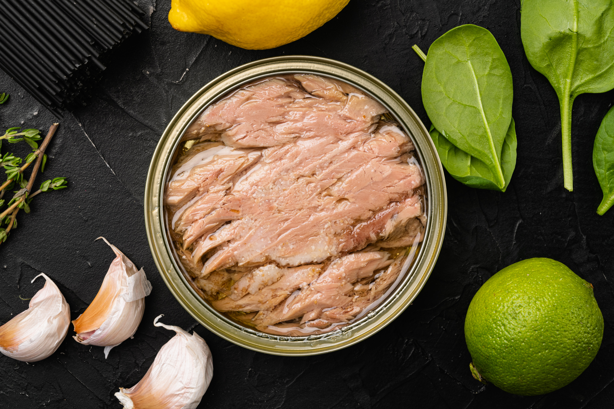 Tonfisk på burk med vitlök och örter runt om