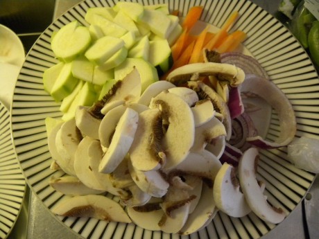 Svamp, morötter och zucchini på vit fat med svarta ränder